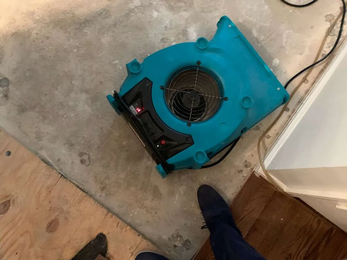 Air mover drying subfloor during Commercial Water Damage Restoration in Capitola